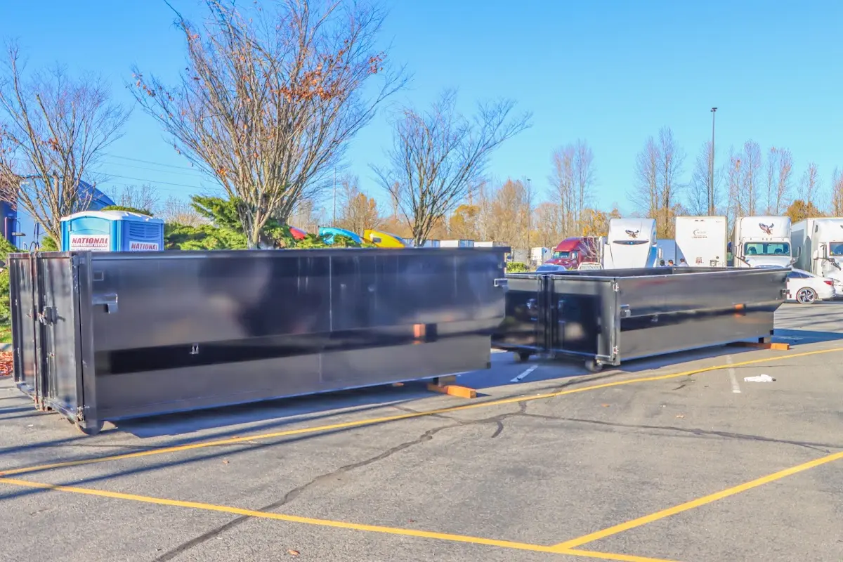 Professional dumpster rental service with roll-off container on residential driveway in Yakima
